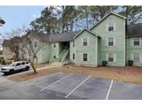 Green multi-Gathering home featuring on-site parking and lush trees at 6241 Rolling Fork Rd # C, North Charleston, SC 29406