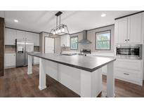 Spacious kitchen showcasing a large center island, modern lighting, and ample counter space at 108 Swanson Dr, Summerville, SC 29483