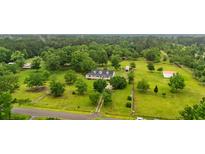 Expansive aerial view of a home with a long driveway, lush greenery, and outbuildings at 117 Ponderosa Rd, Summerville, SC 29483
