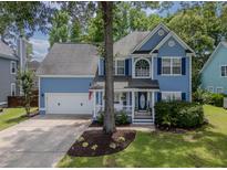 Charming blue two-story home with a well-manicured lawn, white trim, and attached two-car garage at 1250 White Tail Path, Charleston, SC 29414