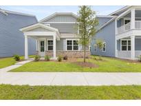 Charming home with a welcoming porch and well-manicured lawn, creating an inviting curb appeal at 133 Brant Dr, Summerville, SC 29483