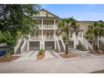 Charming two-story home with double porches, garages, and mature landscaping for curb appeal at 1454 Carradale Ln, Mount Pleasant, SC 29466