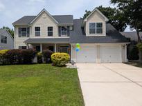 Charming two-story home with a manicured lawn, and a two-car garage at 164 Historic Dr, Mount Pleasant, SC 29464