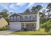 Charming two-story home with stone accents, covered porch and an attached two car garage at 165 Clydesdale Cir, Summerville, SC 29486