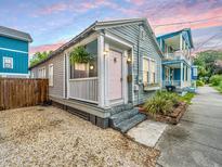 Charming single-story home showcasing a quaint porch, light-blue siding, and tidy landscaping at 202 Fishburne St, Charleston, SC 29403