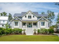 Charming two-story home with landscaped front yard and inviting staircase leading to the entrance at 3871 Sawyers Island Dr, Mount Pleasant, SC 29466