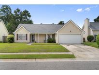 Charming single-story home with a well-maintained lawn and attached garage, offering curb appeal at 432 Equinox Cir, Ladson, SC 29456
