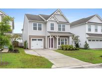Charming two-story home with a well-manicured lawn, inviting entryway and attached garage at 514 Purple Finch Rd, Summerville, SC 29486