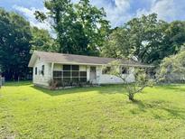 Quaint single-story home with a well-maintained lawn and mature trees providing shade at 524 Kell Pl, Charleston, SC 29412