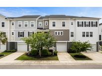 Charming townhome with attached garages, neutral siding, manicured lawn and beautiful, mature landscaping at 582 Mclernon Trce, Johns Island, SC 29455