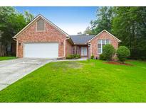 Charming one-story brick home with a well-manicured lawn and attached two-car garage at 100 Cheshire Dr, Goose Creek, SC 29445