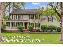 Charming two-story home with a well-maintained lawn and a welcoming front porch at 109 Fort St, Summerville, SC 29485