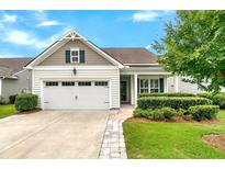 Charming single-Gathering home featuring a well-maintained lawn, manicured shrubs, and an attached two-car garage at 117 Harbor Trace Ln, Summerville, SC 29486
