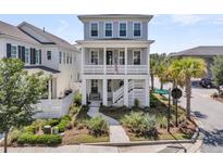 Charming two-story home featuring a welcoming porch, lush landscaping, and a 'Welcome Dr' street sign at 1182 Welcome Dr Dr, Mount Pleasant, SC 29464