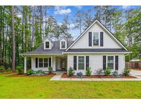 Charming white two-story home with a landscaped front yard and black shutters at 206 Almond Ct, Summerville, SC 29483