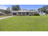 Charming single-story brick home with a cozy front porch and a well-maintained lawn at 212 Columbia Dr, Ladson, SC 29456