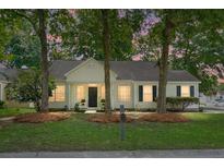 Charming one-story home with mature trees, well-maintained lawn, and inviting front entrance at 2701 Four Winds Pl, Mount Pleasant, SC 29466