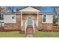Charming brick home with a covered porch and white railings at 2829 Ranger Dr, North Charleston, SC 29405