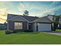 Charming one-story brick home with attached two car garage and well maintained lawn at 286 Westbrooke Rd, Summerville, SC 29486