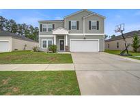 Charming two-story home with attached garage, well-manicured lawn, and inviting curb appeal at 309 Squire Pope Rd Rd, Summerville, SC 29486