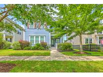Charming two-story home with a well-manicured lawn and beautiful landscaping at 310 Marchman St, Summerville, SC 29486