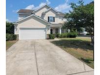 Two-story home featuring a wide driveway, attached two-car garage, and a well-maintained lawn at 340 Albrighton Way, Moncks Corner, SC 29461