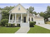 Charming home featuring a welcoming front porch, manicured lawn, and a two-car garage at 3520 E Higgins Dr, Mount Pleasant, SC 29466