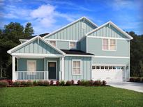 Charming two-story home featuring a welcoming front porch and a two-car garage at 421 Radiant Blue Way, Summerville, SC 29486