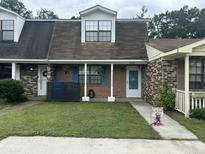 Charming brick townhouse with a well-maintained lawn and welcoming front porch at 5021 Popperdam Creek Dr, North Charleston, SC 29418