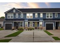 Charming townhomes featuring blue siding, black garage doors, and well-maintained landscaping at 5133 Park Creek Ave, North Charleston, SC 29418