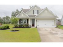 Charming single-Gathering home with a manicured lawn and attached two-car garage at 683 Yellow Leaf Ln, Summerville, SC 29486