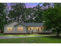 Charming single-story home featuring a cozy porch and landscaped front yard at 785 Coral Acres Dr, Moncks Corner, SC 29461