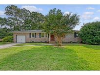 Charming brick ranch home with a manicured lawn and mature trees in a desirable neighborhood at 1 Bossis Dr, Charleston, SC 29407