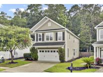 Charming two-story home with a well-maintained yard, two-car garage, and tasteful landscaping at 110 Instructor Ct, Ladson, SC 29456