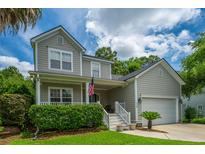 Charming two-story home with well-maintained landscaping and a covered front porch at 1409 Bloomingdale Ln, Mount Pleasant, SC 29466