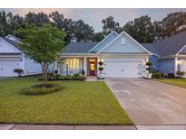 Charming single-story home with a well-manicured lawn, red door, and attached two car garage at 148 Longdale Dr, Summerville, SC 29483