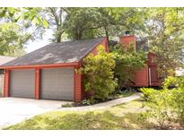 Charming exterior of red home featuring an attached two-car garage and well-maintained landscaping at 152 Mansfield Blvd, Charleston, SC 29418