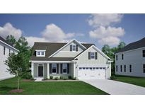 Charming two-story home featuring a two-car garage, manicured lawn, and inviting front porch at 173 Grange Cir, Summerville, SC 29486
