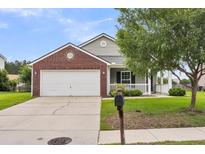 Charming single-Gathering home featuring a brick facade, inviting front porch, and a two-car garage at 173 Southport Dr, Summerville, SC 29483
