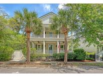 Charming two-story home with double porches framed by beautiful palm trees, embodying Southern charm at 183 Civitas St, Mount Pleasant, SC 29464