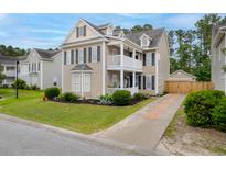 Charming two-story home boasts a double porch, well-maintained landscaping, and a private driveway and garage at 234 Cameron St, Summerville, SC 29486
