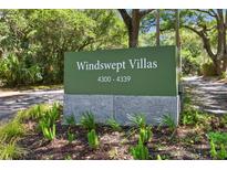 A sign for Windswept Villas features the address range and manicured landscaping at 4303 Sea Forest Dr, Kiawah Island, SC 29455