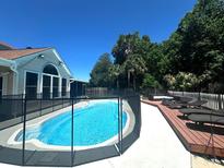 Beautiful backyard pool with secure fencing and sunny lounge area at 6212 Fieldstone Cir, Charleston, SC 29414