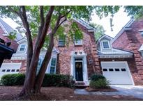 Charming brick home with a black front door, two-car garage, and mature tree in the front yard at 760 Natchez Circle Cir, Mount Pleasant, SC 29464