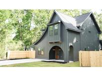 Charming new construction featuring dark siding, arched entryway, and craftsman details at 868 Tripe St, Charleston, SC 29407