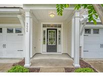 Welcoming front entrance with a black door, sidelights, and a covered porch at 9646 Scarborough Ct, Summerville, SC 29485