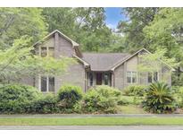 Charming brick home with mature landscaping and a welcoming front facade at 103 Kenninghall Rd, Goose Creek, SC 29445