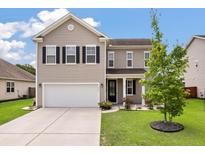 Charming two-story home with a well-manicured lawn, attached garage and a welcoming facade at 111 Nolin Road Rd, Moncks Corner, SC 29461