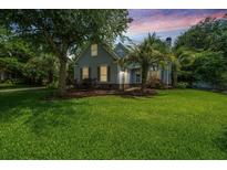 Charming two-story home with lush landscaping, mature trees, and beautiful lawn at 2031 Thornhill Dr, Summerville, SC 29485