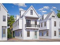 Charming new construction home featuring a balcony, painted siding and a welcoming entrance, ideal for coastal living at 25 Nats Ct, Charleston, SC 29403